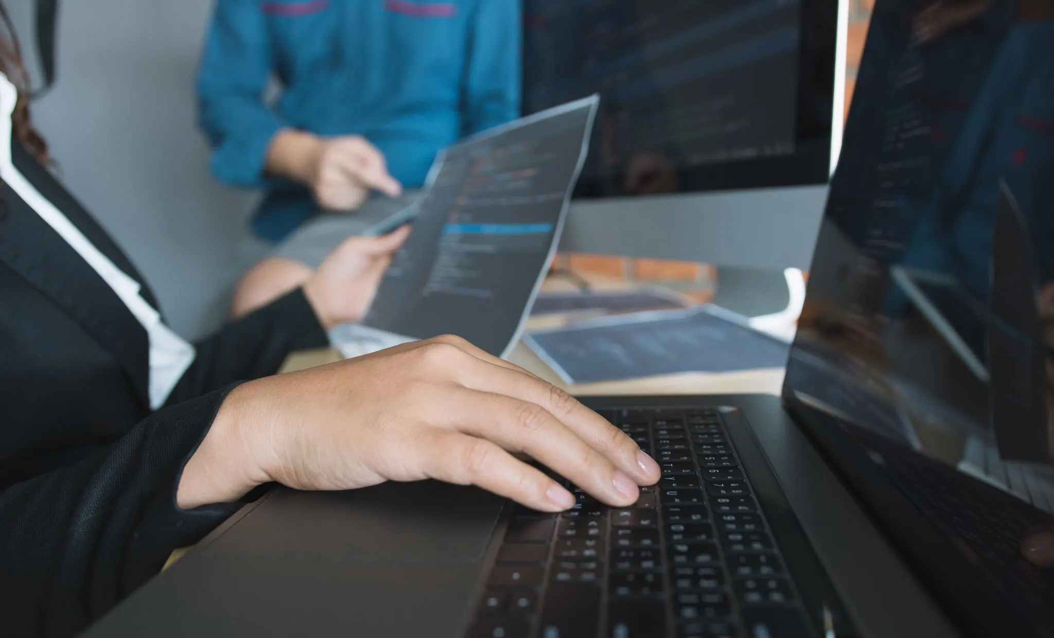 IT professionals reviewing software code